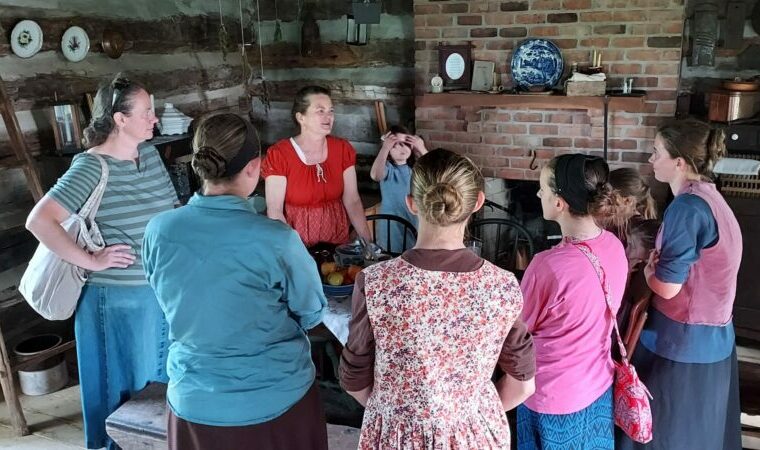 visitors learning about how early settlers live in AuGlaize Village